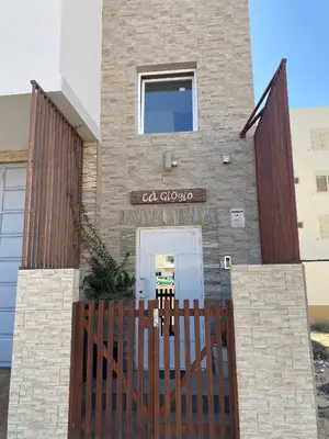 a house with a wooden gate in front of it at Ca GIOgió in Santa Maria