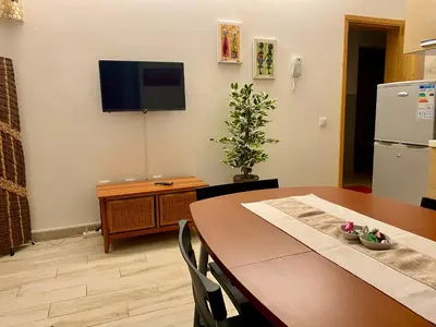 a dining room with a table and a television on a wall at Ca GIOgió in Santa Maria