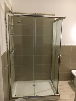 a shower with a glass door in a bathroom at Ca GIOgió in Santa Maria