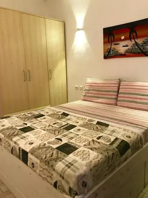 a bedroom with a bed with a quilt on it at Ca GIOgió in Santa Maria