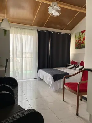 a bedroom with a bed with a black curtain at Christian Place in Praia