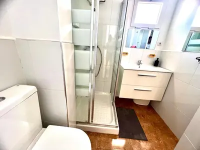 a bathroom with a shower and a toilet and a sink at DAISAL APARTMENT - 2 bedroom apartment with balcony near the beach & city center in Santa Maria