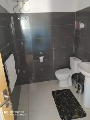a bathroom with a toilet and a sink at Guest House Maio in Vila do Maio