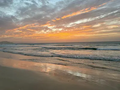 a sunset on a beach with the ocean at Villa Nº25b Alfredo Marchetti suites on the beach Praia di Chaves in Cabeçadas