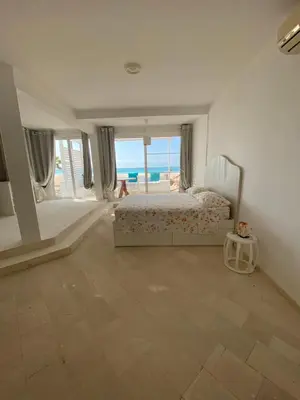 a bedroom with a bed and a view of the ocean at Villa Nº25b Alfredo Marchetti suites on the beach Praia di Chaves in Cabeçadas
