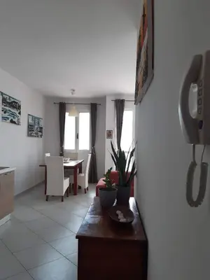 a living room with a phone hanging on a wall at App Raffaele Estoril Beach Free Wifi & AC a step away from the sea in Sal Rei