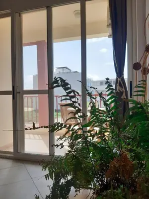 a room with glass doors and a plant at App Raffaele Estoril Beach Free Wifi & AC a step away from the sea in Sal Rei