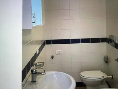a bathroom with a sink and a toilet at Leme Bedje GST84 3 bedroom apt with Panaramic views in Santa Maria
