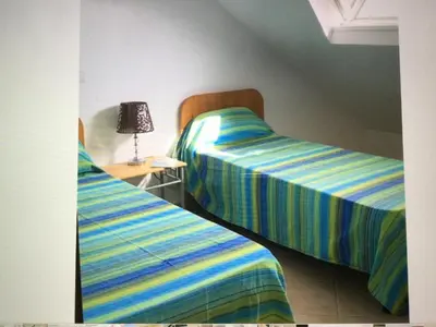 two beds sitting next to each other in a room at Leme Bedje GST84 3 bedroom apt with Panaramic views in Santa Maria