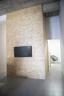 a living room with a stone wall with a tv on it at Urban Sal Loft in Espargos