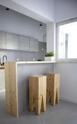 a kitchen with a counter with two wooden stools at Urban Sal Loft in Espargos