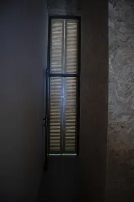 a door in a room with a window with blinds at Urban Sal Loft in Espargos