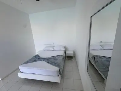 a white room with two beds and a mirror at Académico do Sal in Espargos
