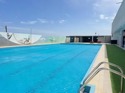 a large swimming pool with blue water in a building at Académico do Sal in Espargos