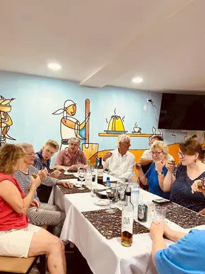 a group of people sitting at a table at Hotel Vista in Praia
