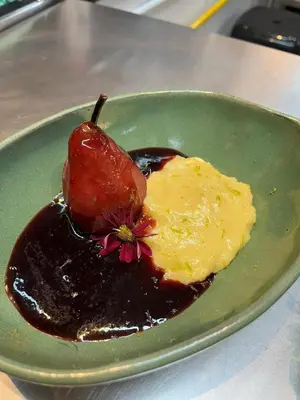 a green plate with chocolate sauce and a flower on it at Hotel Vista in Praia