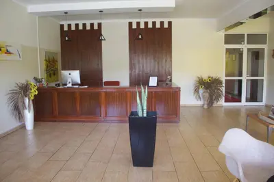 a lobby with a reception desk and a waiting room at Falucho Paradise Beach in Pedra Badejo