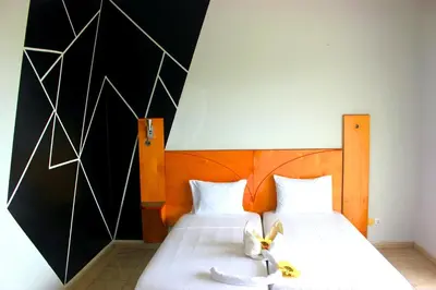 a bedroom with two beds with white sheets at Falucho Paradise Beach in Pedra Badejo