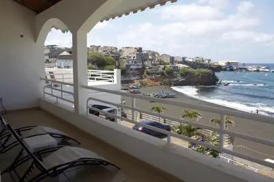 a balcony with chairs and a view of the ocean at Falucho Paradise Beach in Pedra Badejo