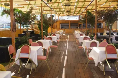 a row of tables and chairs in a restaurant at Falucho Paradise Beach in Pedra Badejo