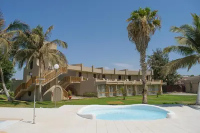 a resort with palm trees and a building at Oasis Praiamar in Praia