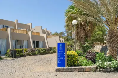 a blue sign in front of a building at Oasis Praiamar in Praia