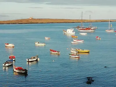a group of boats in a large body of water at Villa Pescadora spectacular view, luxery fisherhouse design in Sal Rei