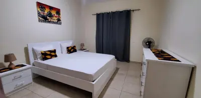 a bedroom with a large white bed and a desk at Apartamento Teixeira in Espargos