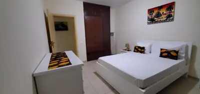 a white bedroom with a bed and a desk at Apartamento Teixeira in Espargos