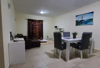 a living room with a table and chairs and a couch at Apartamento Teixeira in Espargos