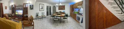 a kitchen and living room with a table and chairs at Beach Townhouse - Murdeira Village in Beirona