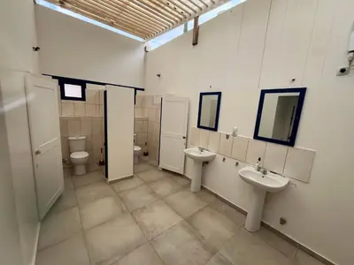 a bathroom with two sinks and two toilets at Quintal do Maio in Vila do Maio