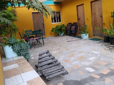a patio with a table and chairs in a building at Ecolodge Ribeira Principal in Xá Xá