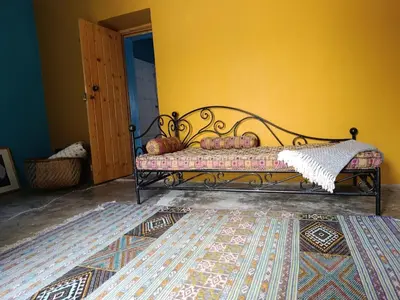 a bed in a room with a yellow wall at Ecolodge Ribeira Principal in Xá Xá