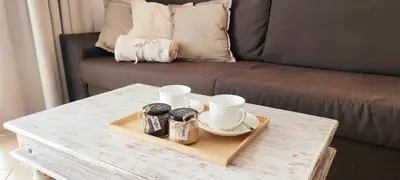 a coffee table with a tray with two mugs and a tea set at Sunset house Cabo Verde in Santa Maria