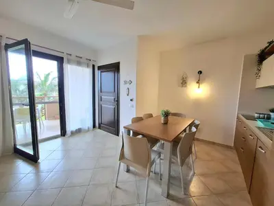 a kitchen and dining room with a table and chairs at Sunset house Cabo Verde in Santa Maria
