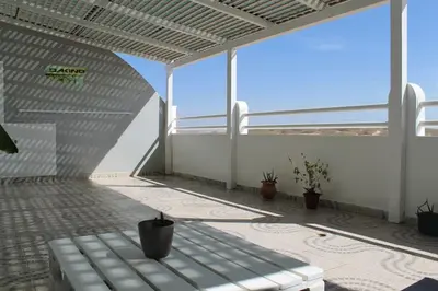 an empty patio with a bench on a balcony at Tropical Leaves Sea view penthouse ca Greta 2 floor in Sal Rei