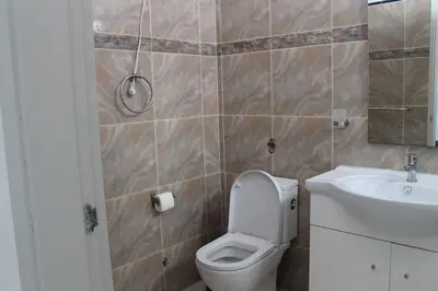 a bathroom with a toilet and a sink at Tropical Leaves Sea view penthouse ca Greta 2 floor in Sal Rei