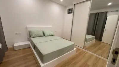 a white bedroom with a bed and a mirror at Duarte Apartments - Lux in Mindelo