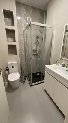 a bathroom with a shower and a toilet and a sink at Duarte Apartments - Lux in Mindelo