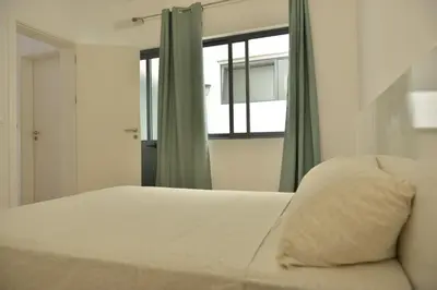 a bedroom with a white bed and a window at Duarte Apartments - Lux in Mindelo