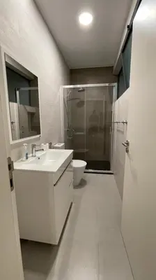 a bathroom with a sink and a shower and a toilet at Duarte Apartments - Lux in Mindelo