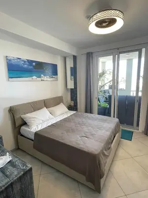 a bedroom with a large bed and a large window at Luxury Beachhouse Apartment Boa Vista in Sal Rei