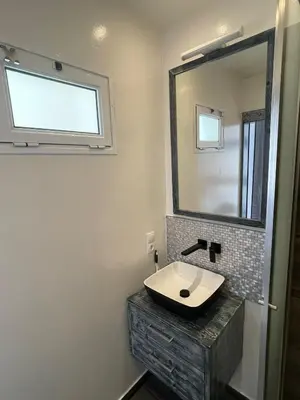 a bathroom with a sink and a mirror at Luxury Beachhouse Apartment Boa Vista in Sal Rei
