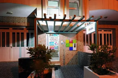 a restaurant with plants in front of a building at Atlantic Sal Hostel in Santa Maria