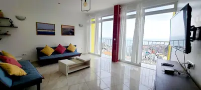 a living room with a couch and a large window at LA MENOR in Ribeira Grande