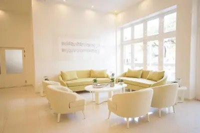a living room with couches and a table and chairs at Oasis Porto Grande in Mindelo