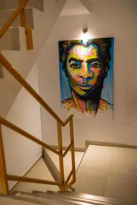 a painting of a woman on a wall at Apartamento Fátima Amwilla Guesthouse in Mindelo