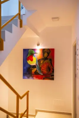 a painting of a bird on a wall at Apartamento Fátima Amwilla Guesthouse in Mindelo