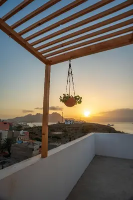 a view of the sunset from the balcony of a house at Apartamento Fátima Amwilla Guesthouse in Mindelo